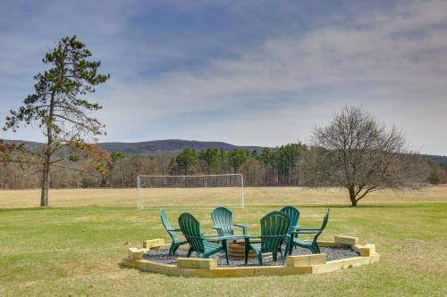 a group of chairs sitting around a table in a field at 4 Mi to Great Barrington Berkshires Retreat! in Sheffield