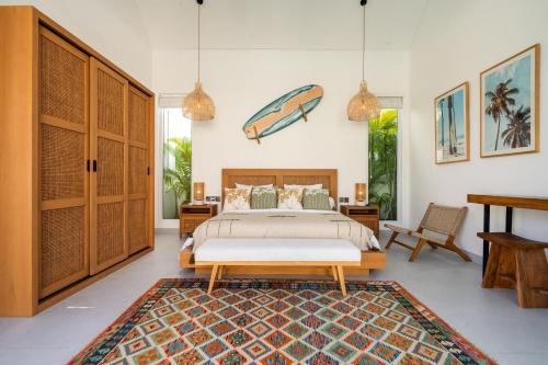 a bedroom with a bed and a rug at Villa Casa Blanca, Bingin Beach in Uluwatu