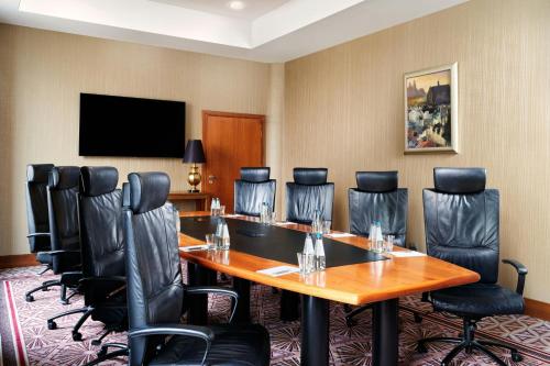 a conference room with a large table and chairs at Sheraton Grand Krakow in Kraków