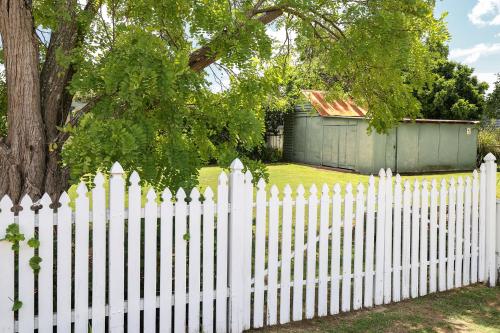 a white picket fence in front of a house at Ellson House - The Heart of the Hunter in Cessnock