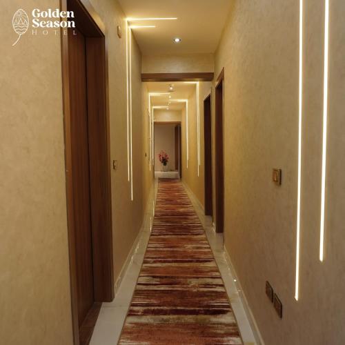 a hallway with a long aisle with wood floors at Golden Season Hotel in Cairo