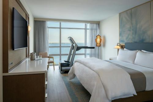 a hotel room with a bed and a treadmill at The Westin Tampa Bay in Tampa