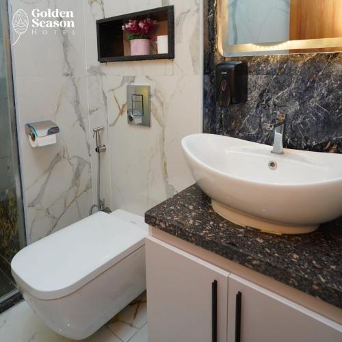 a bathroom with a sink and a toilet at Golden Season Hotel in Cairo