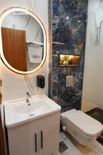 a bathroom with a sink and a toilet and a mirror at Golden Season Hotel in Cairo