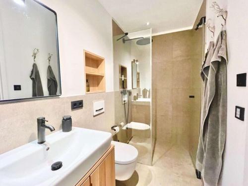 a bathroom with a sink and a toilet and a shower at Holiday apartment Bergliebe on Lake Tegernsee in Rottach-Egern