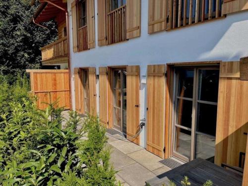 a building being constructed with wooden doors and windows at Holiday apartment Bergliebe on Lake Tegernsee in Rottach-Egern