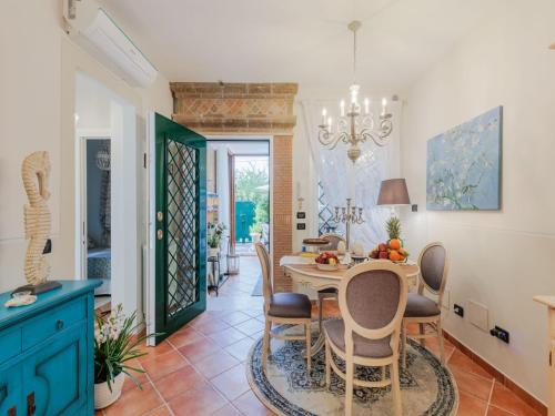 a kitchen and dining room with a table and chairs at Apartment near Ostia Antica with Jacuzzi in Torvaianica