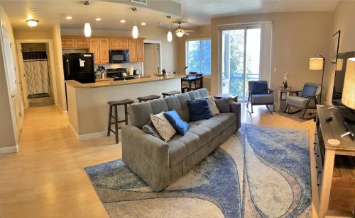 a living room with a couch and a kitchen at 1-Bedroom Condo in the Heart of the City in Salt Lake City