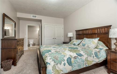 a bedroom with a bed and a dresser and a mirror at 1-Bedroom Condo in the Heart of the City in Salt Lake City