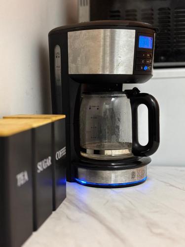a black coffee maker sitting on top of a counter at The Ivy Cinema Suite in Luton