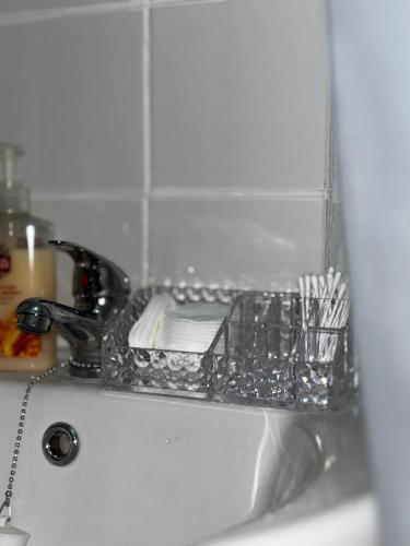 a drying rack on a sink in a bathroom at The Ivy Cinema Suite in Luton