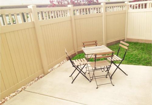 a patio with a table and chairs next to a fence at Downtown Condo Near Convention Center (Disability Access) in Salt Lake City