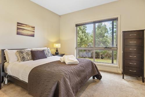 a bedroom with a bed and a window at Tides Reach in Dover