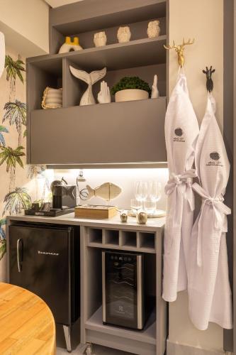 a kitchen with white towels hanging on a shelf at Arpoar Suite N 130 in João Pessoa
