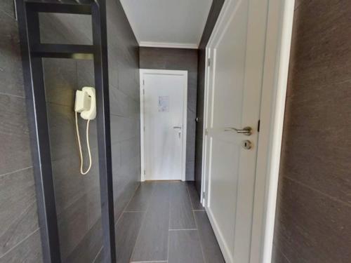 a hallway with a phone next to a door at Studio in Middelkerke with Sea View in Middelkerke
