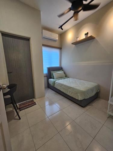 a bedroom with a bed and a ceiling fan at CozyHome - 3 bedroom Town House with unlimited free Wi-Fi in Sitiawan