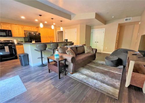 a living room with a couch and a kitchen at 3-Bedroom Luxury Condo in the Heart of the City in Salt Lake City