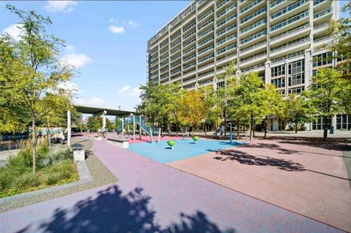 a park in front of a building with a playground at CN Tower Luxe Suites - Prime Downtown Location in Toronto