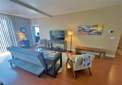 a living room with a couch and a table and chairs at Deluxe Downtown Condo Close to Everything! in Salt Lake City
