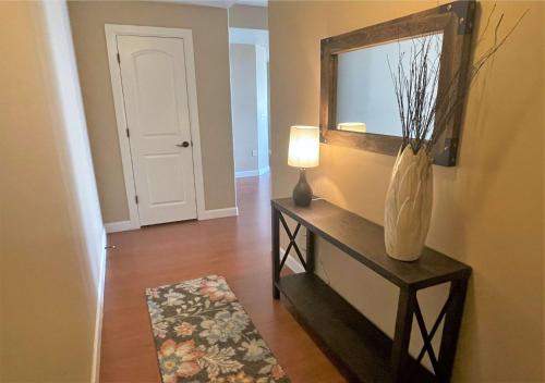 a room with a mirror and a table with a vase at Deluxe Downtown Condo Close to Everything! in Salt Lake City