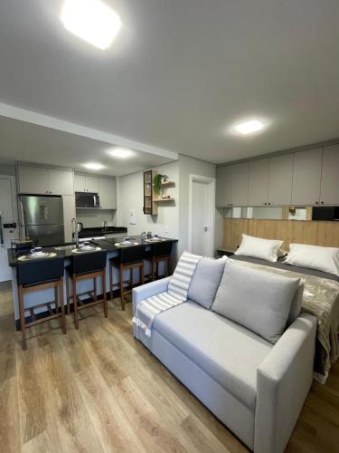 a living room with a couch and a kitchen at Konell apartment 102 in Pomerode