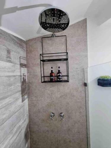a bathroom with a shower with two bottles on a shelf at 0 - Suite de Lujo Confort Cama Queen Size Roma Sur in Mexico City