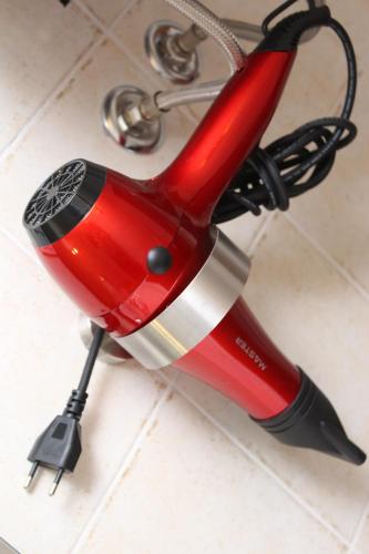 a red and silver umbrella sitting on a counter at Bed and Breakfast Terra del Sole Ibla in Ragusa