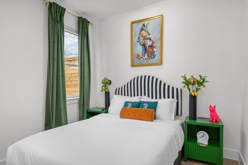 a bedroom with a white bed and a window at Elegant home with Houston cityscape and rooftop in Houston