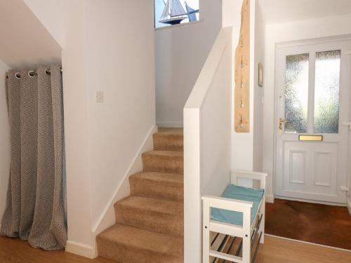 a staircase in a home with a stair case at Hafan Bach - 233 Cae Du in Abersoch