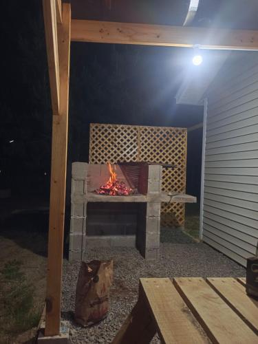 a patio with a fire pit at night at Cabañitas Zelada in Algarrobo