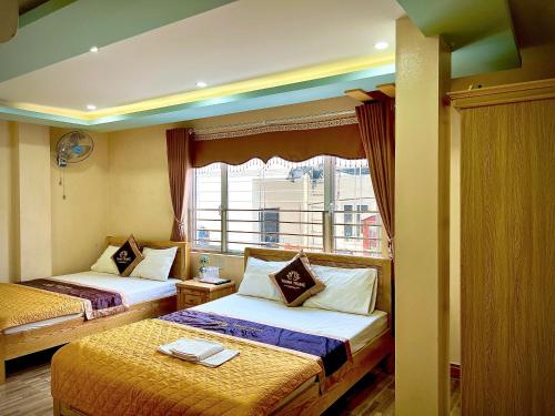 Ένα ή περισσότερα κρεβάτια σε δωμάτιο στο Thanh Trung Hotel