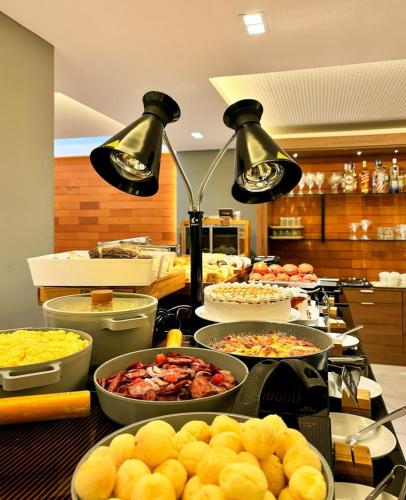 een buffet met veel verschillende gerechten op tafel bij Arpoar Suite N 130 in João Pessoa
