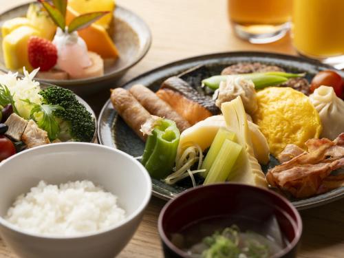 a table with plates of food on a table at Hotel SUI Kyoto Kiyomizu in Kyoto