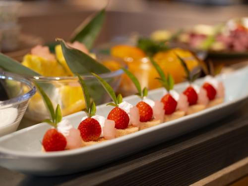 a plate with strawberries and marshmallows on a table at Hotel SUI Kyoto Kiyomizu in Kyoto