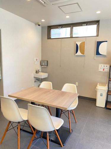 a conference room with a wooden table and chairs at Floral Hotel · SakaisuJi-Honmachi Osaka in Osaka