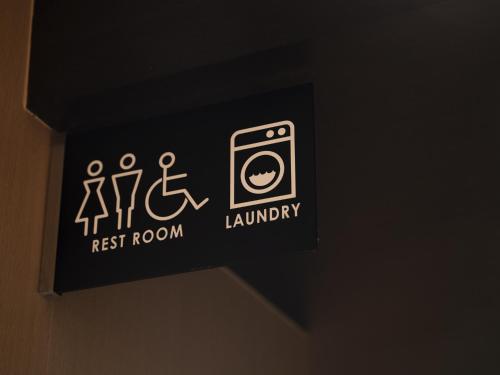 a restroom sign on the wall in a bathroom at Hotel SUI Kyoto Kiyomizu in Kyoto