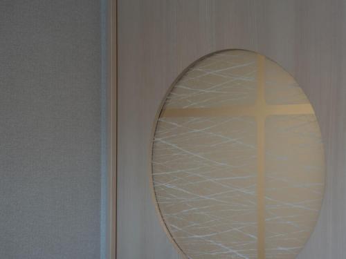 a mirror on a wall with a cross in it at Hotel SUI Kyoto Kiyomizu in Kyoto