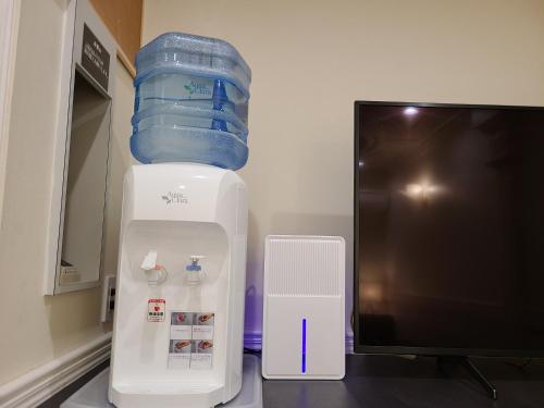 a water cooler sitting next to a computer monitor at Pal Annex Matsubase in Uki