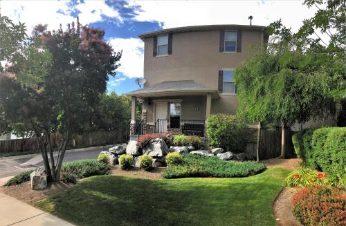a house with a garden in front of it at Spacious Townhome Near Downtown in Salt Lake City