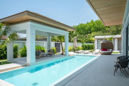 an image of a swimming pool in a house at Mouana Breeze Mai Khao VIP 4-bedroom Pool Villa 9913 in Mai Khao Beach