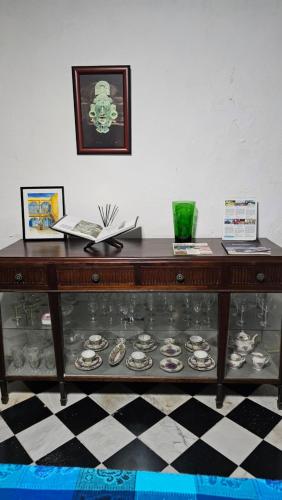a glass display case with plates on it at Casa María en Centro Histórico in Campeche
