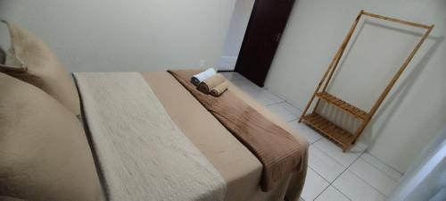 a bedroom with a bed with a mirror and shoes at Casa grande ideal para grupo e empresas in Joinville