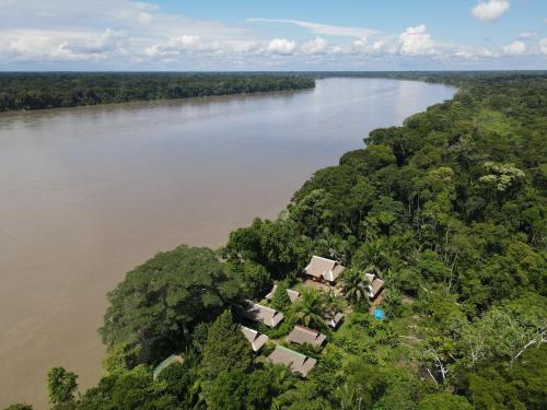 an aerial view of a river with trees and houses at Ecolucerna Lodge Tambopata in Puerto Maldonado