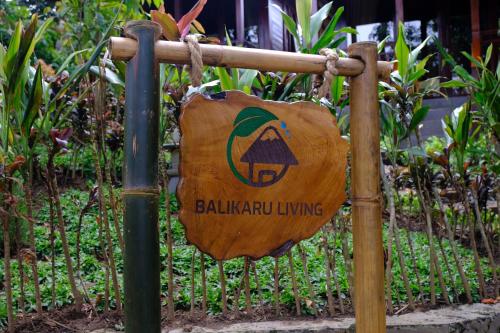 a sign on a fence in a garden at Balikaru Living in Penebel