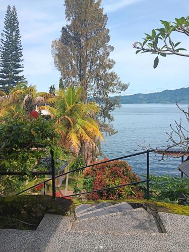 a staircase with a view of a body of water at Toledo Inn in Tuk Tuk