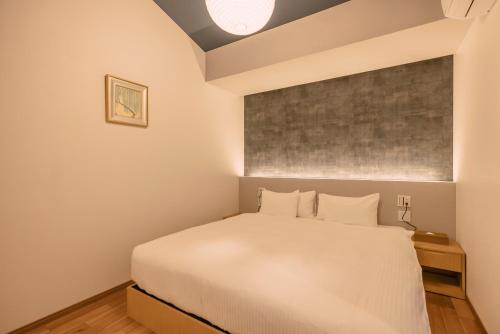 Una cama o camas en una habitación de 谷町君 星屋 東山望月居