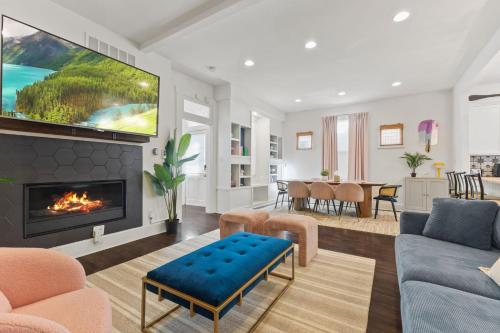 a living room with a fireplace and a tv at Stay & Play Indy- Indoor Fun - 5 Min to Downtown - Sleeps 10 - Arcade fun in Indianapolis