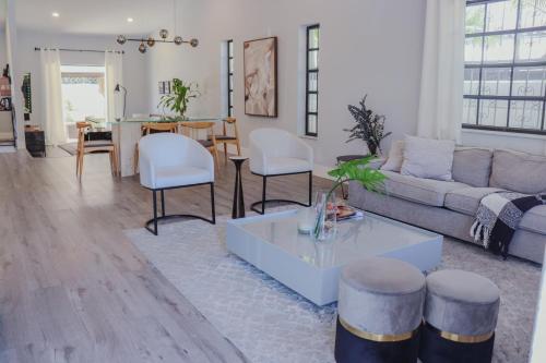 a living room with a couch and a table at Zoka House 5 mints from Brickell in Miami
