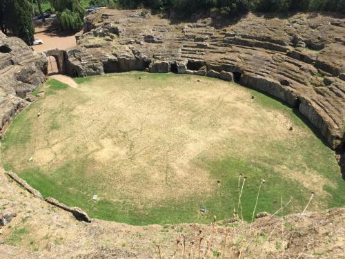 a large field in the middle of a rock wall at Donna Etrusca in Sutri