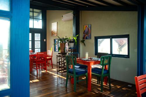 a dining room with a red table and chairs at Hill Village Phu Yen in Phú Hiệp (2)